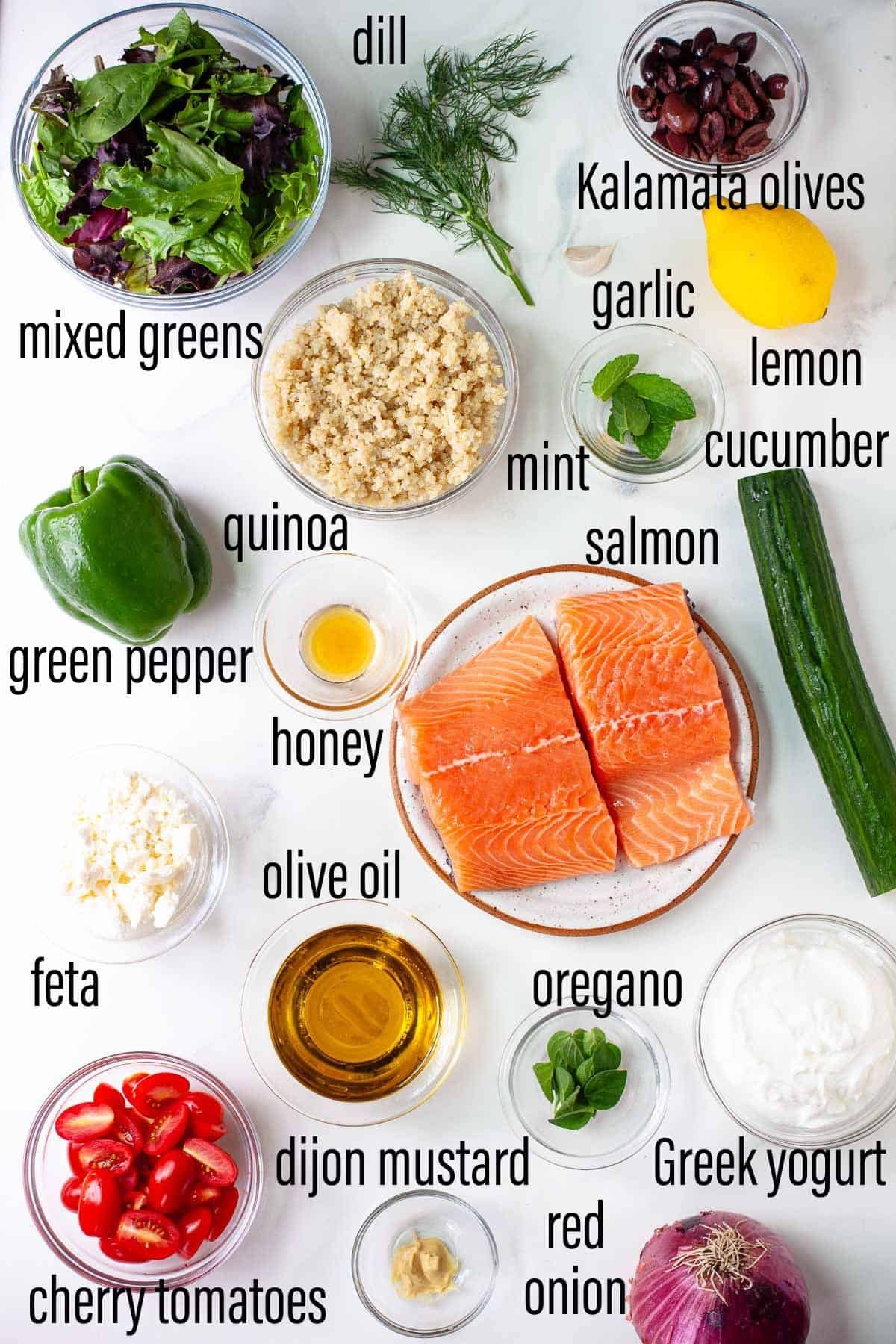 graphic of ingredients for greek salmon quinoa bowl on marble surface with black text overlay.